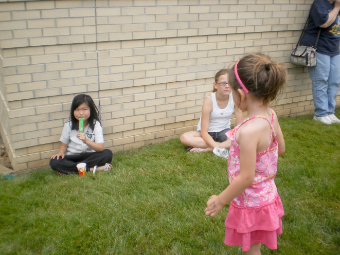 [photo of three girls on the lawn]