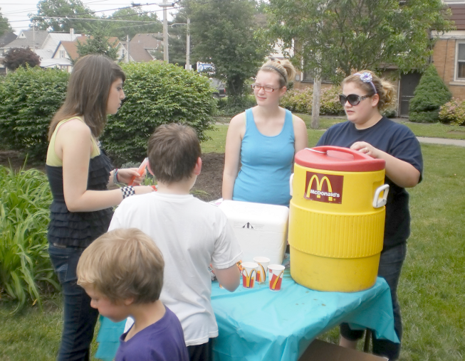[photo of kids and teens standing around a McDonald's punch cooler]